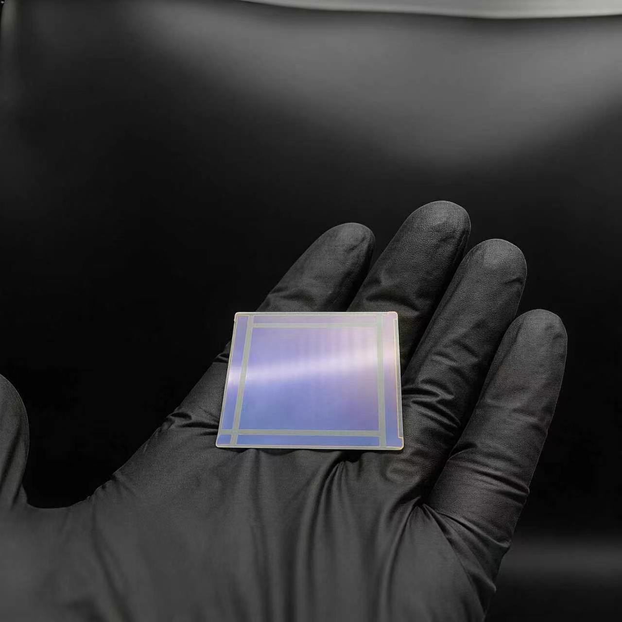 Ultra-thin cover glass sample on gloved hand