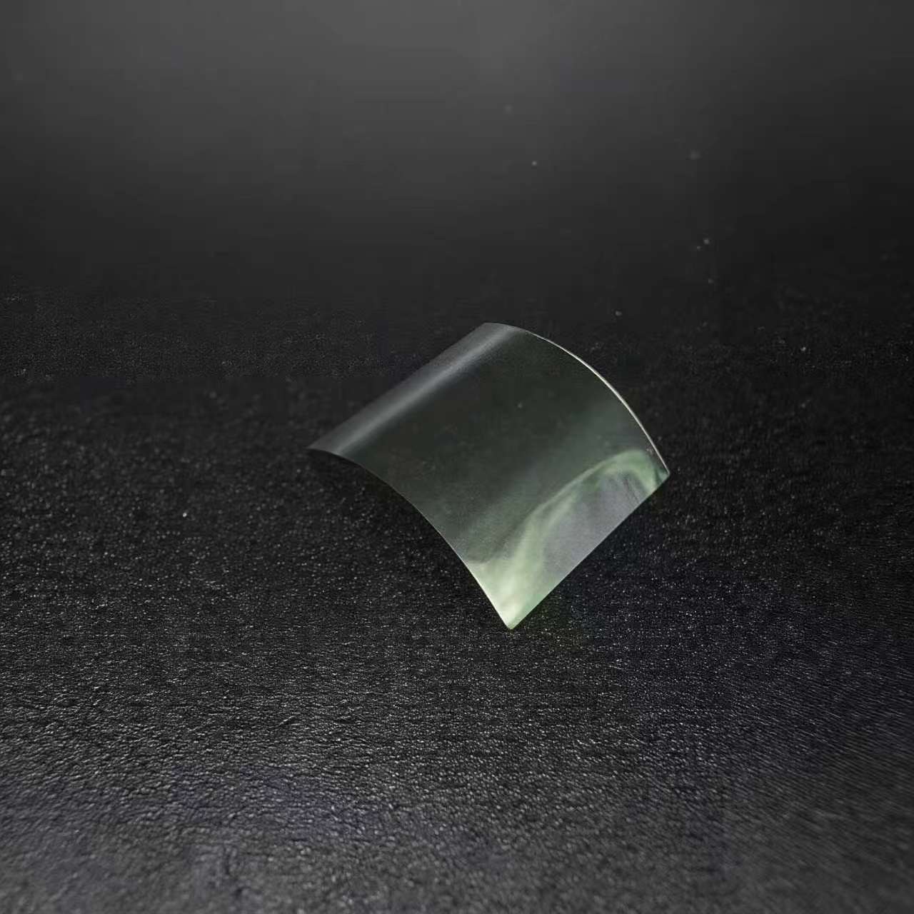 Free-standing SCPI film sample on a dark surface